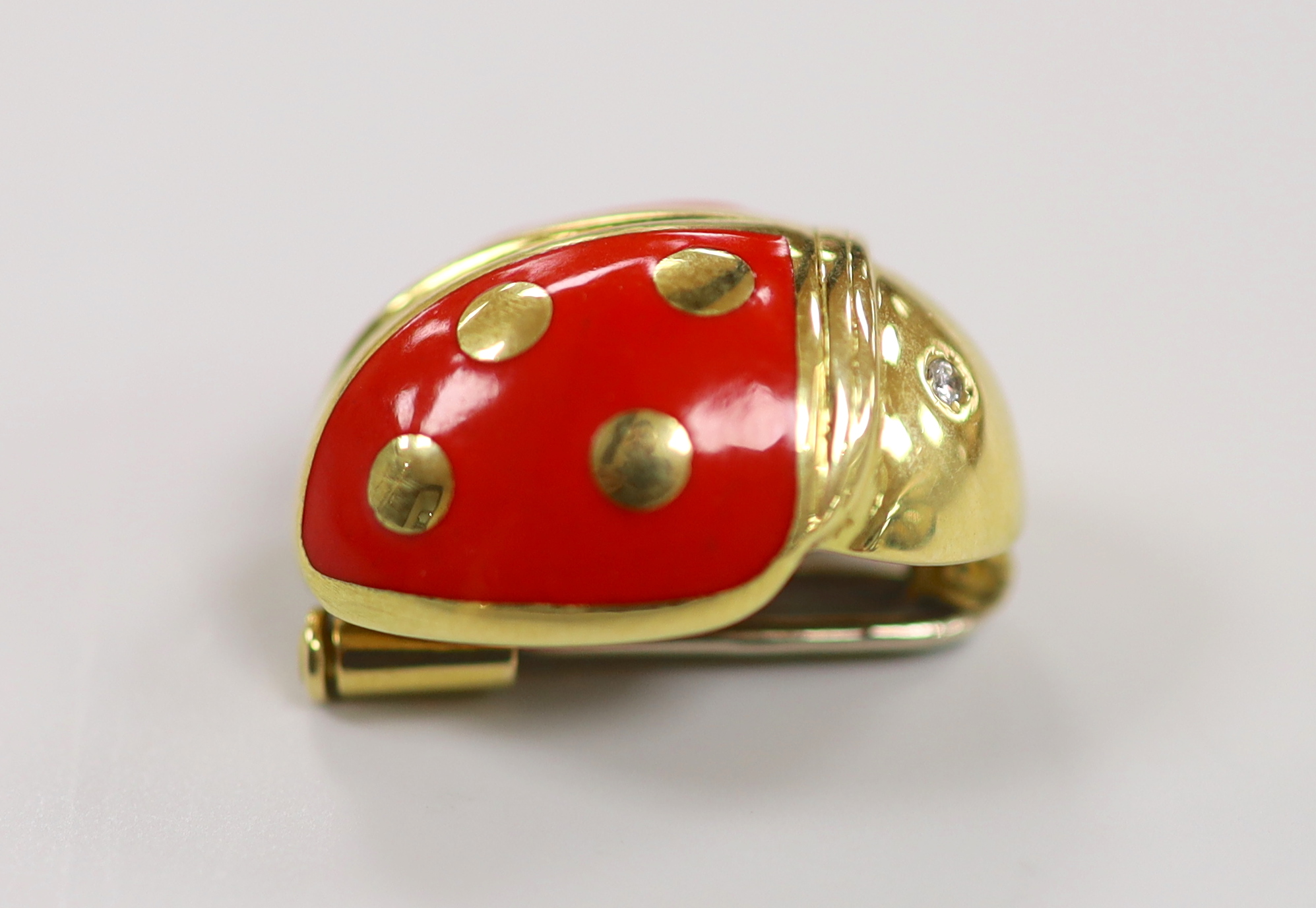 An 18ct gold, enamel and diamond chip set novelty clip brooch, in the form of a ladybird, by Mappin & Webb?, 20mm, gross weight 7.5 grams.